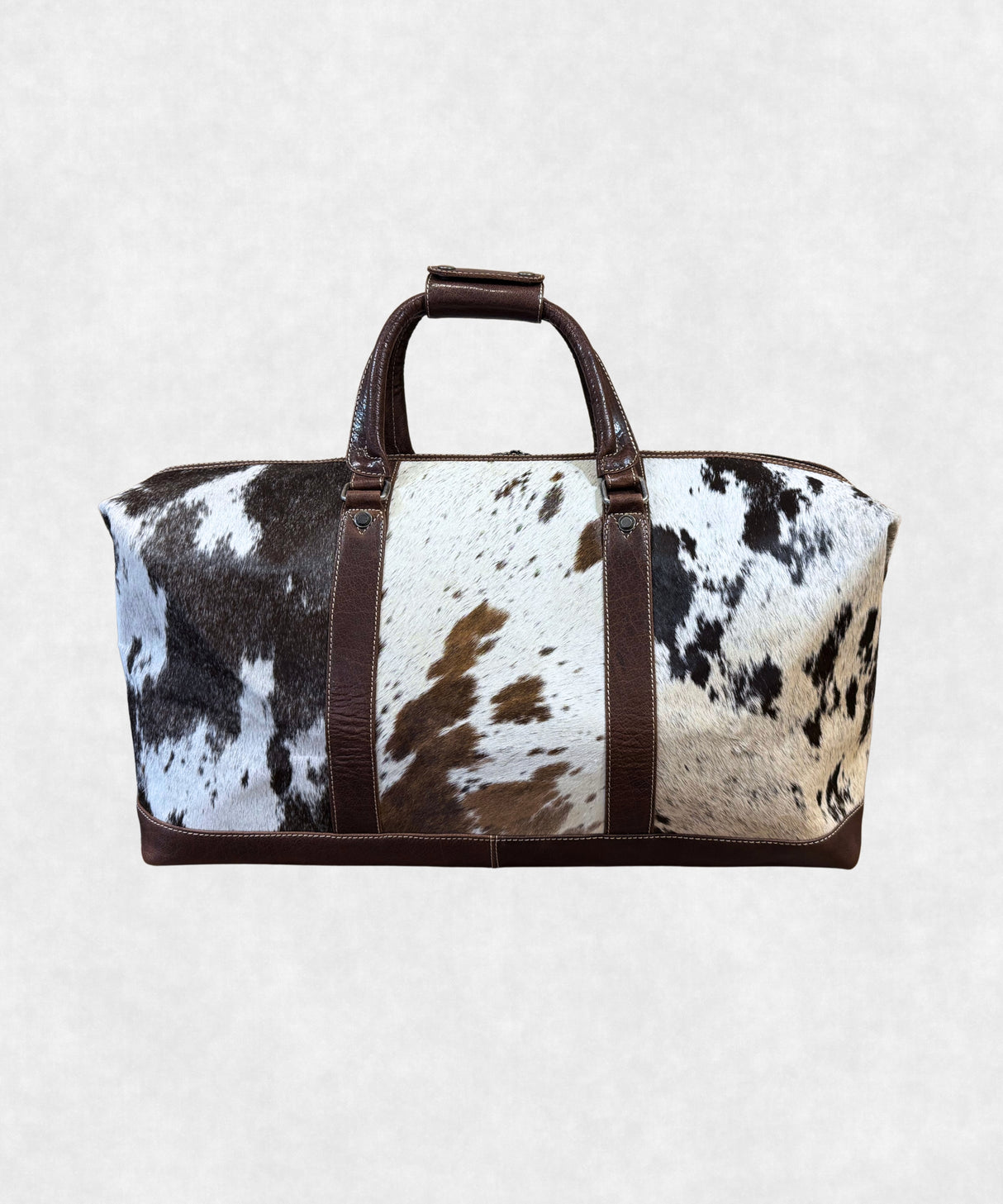 Back view of cowhide leather travel bag highlighting smooth leather finish and sturdy design