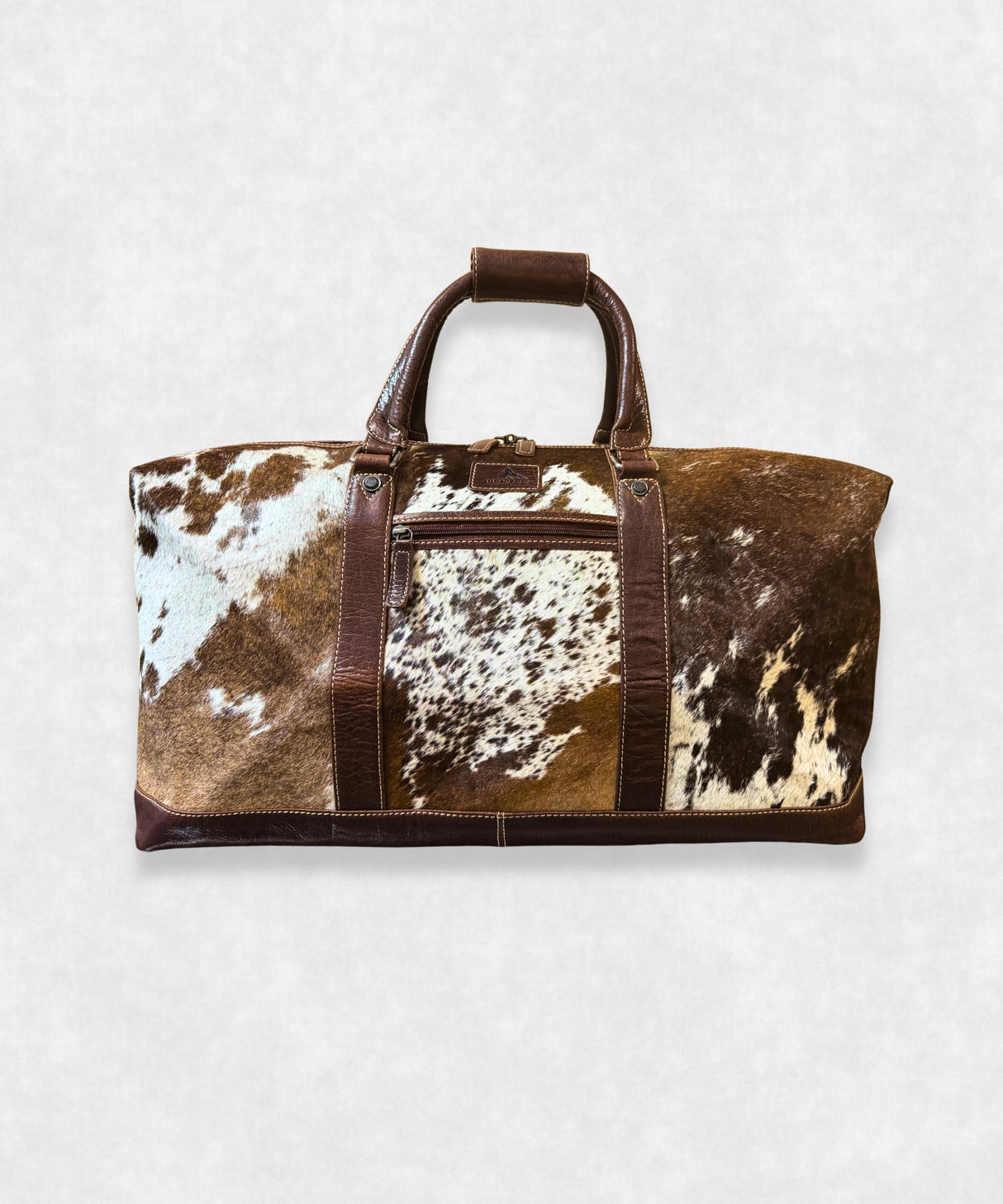 Front view of premium cowhide leather travel bag, durable and stylish for weekend trips