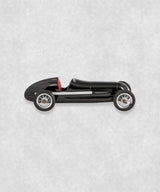 Vintage racing silberfeil car  model inspired by classic Grand Prix racers and Silver Arrow legends, featuring a sleek black race car body with a striking red seat. A collectible car model for motorsport and classic car enthusiasts. Viewed from  the left side.