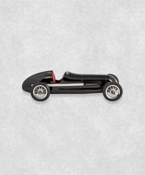 Vintage racing silberfeil car  model inspired by classic Grand Prix racers and Silver Arrow legends, featuring a sleek black race car body with a striking red seat. A collectible car model for motorsport and classic car enthusiasts. Viewed from  the left side.