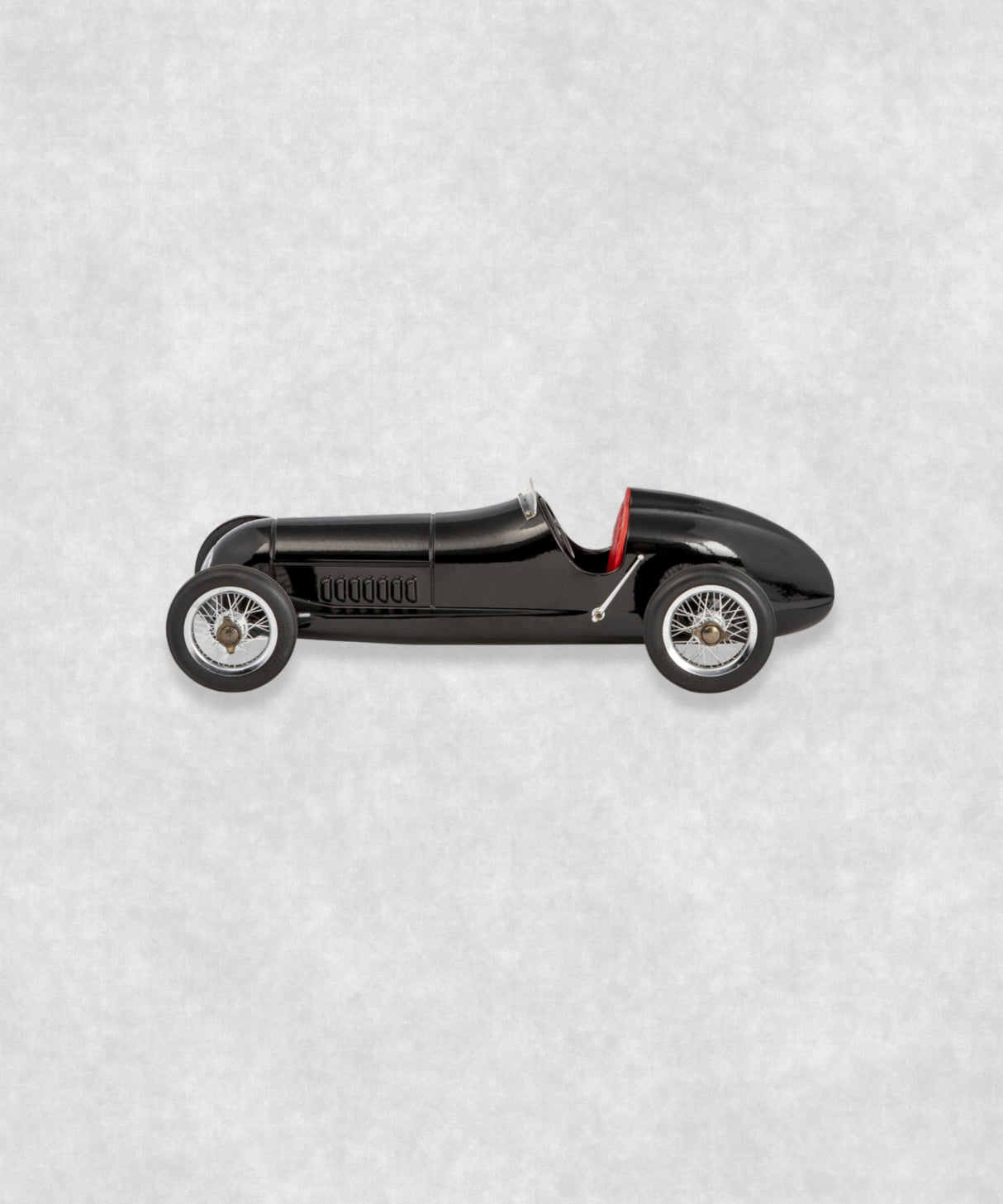 Vintage racing silberfeil car  model inspired by classic Grand Prix racers and Silver Arrow legends, featuring a sleek black race car body with a striking red seat. A collectible car model for motorsport and classic car enthusiasts. Viewed from  the right side.