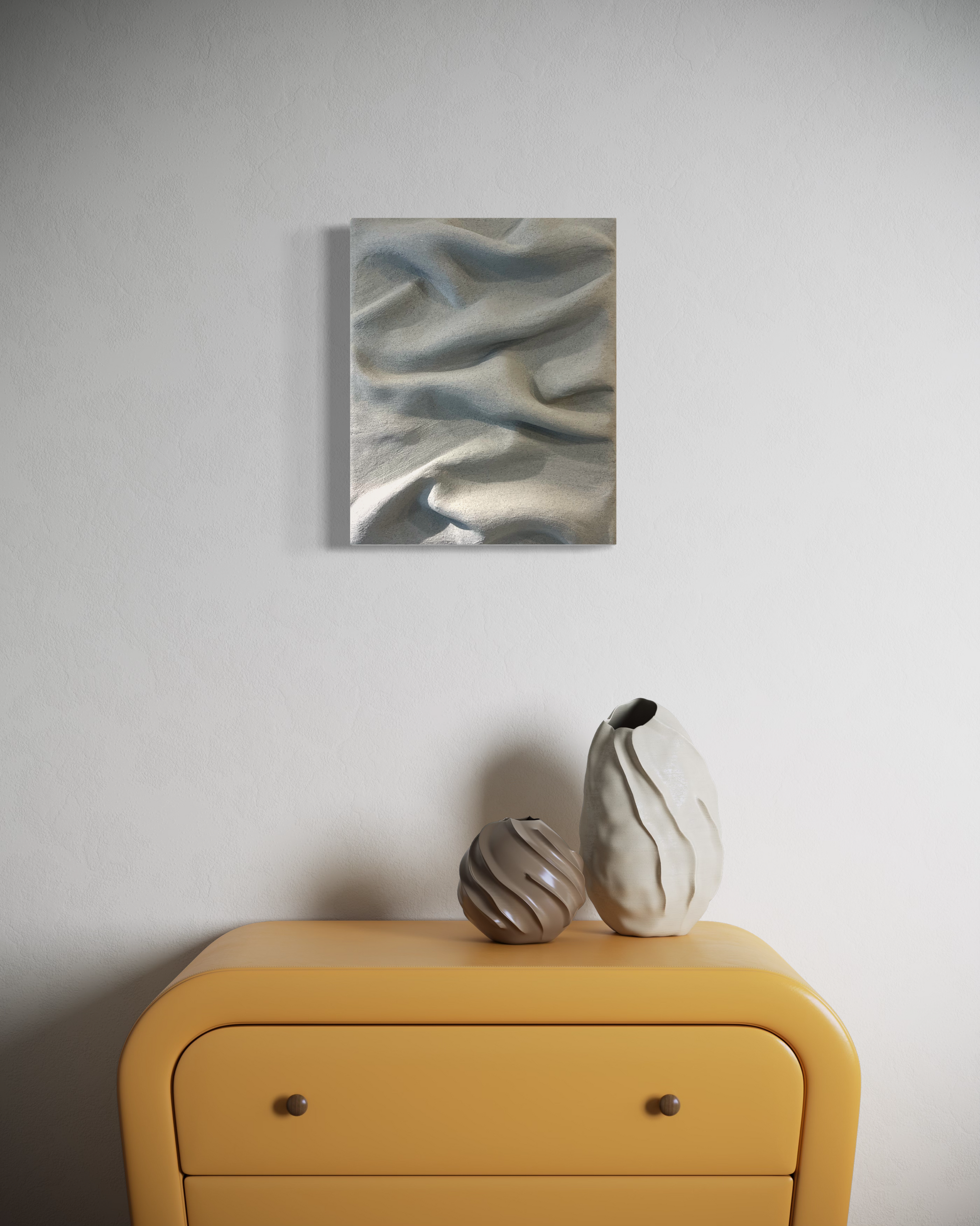 Grey sculptural wall art by Sarah Kvejborg hanging on a light-colored wall.