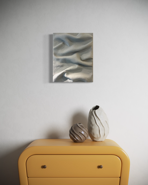 Grey sculptural wall art by Sarah Kvejborg hanging on a light-colored wall.