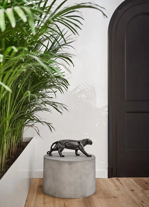 Glossy black porcelain panther sculpture displayed as elegant living room decor, handmade in Spain
