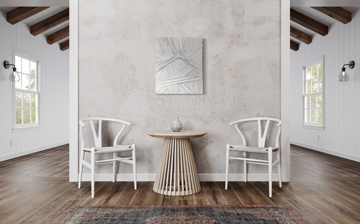 Grey wall sculpture titled "Knot" by Sarah Kvejborg, displayed in a modern interior with light-toned walls and minimalist decor